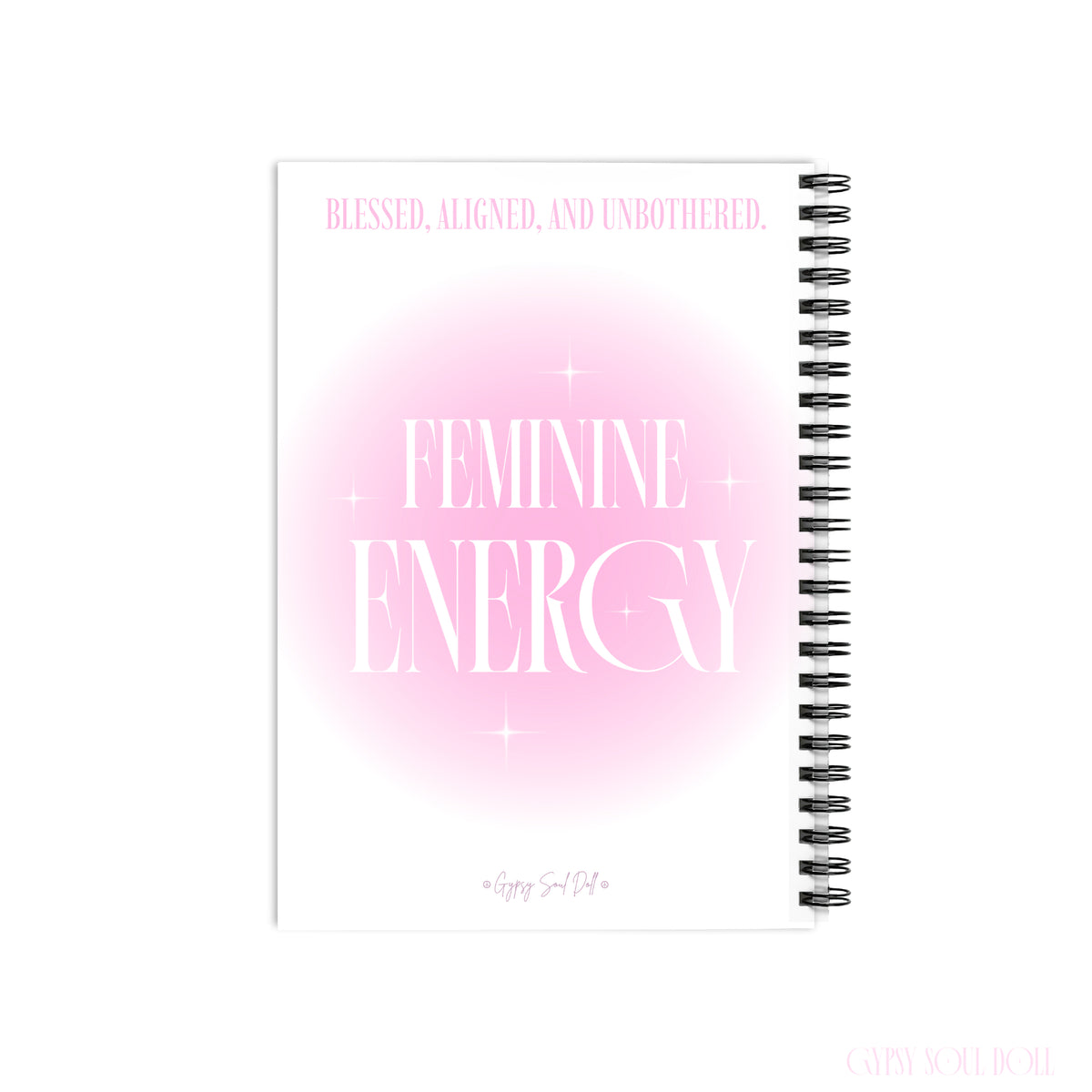 A back cover mockup of a Gypsy Soul Doll manifestation journal featuring a soft pink aura gradient centre with white sparkle stars and tall editorial typography reading Feminine Energy and Blessed Aligned and Unbothered at the top with a signature logo footer at the bottom centred over a white backdrop.