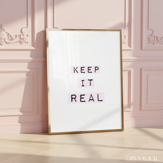 Minimalist typography art print reading Keep It Real with typewriter style font layered over soft pastel pink gradient blocks.