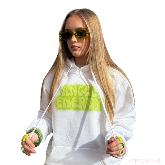 Front view of a model in a white festival graphic hoodie featuring lime green bubble text across the chest, styled with green-tinted fashion glasses and matching accessories.