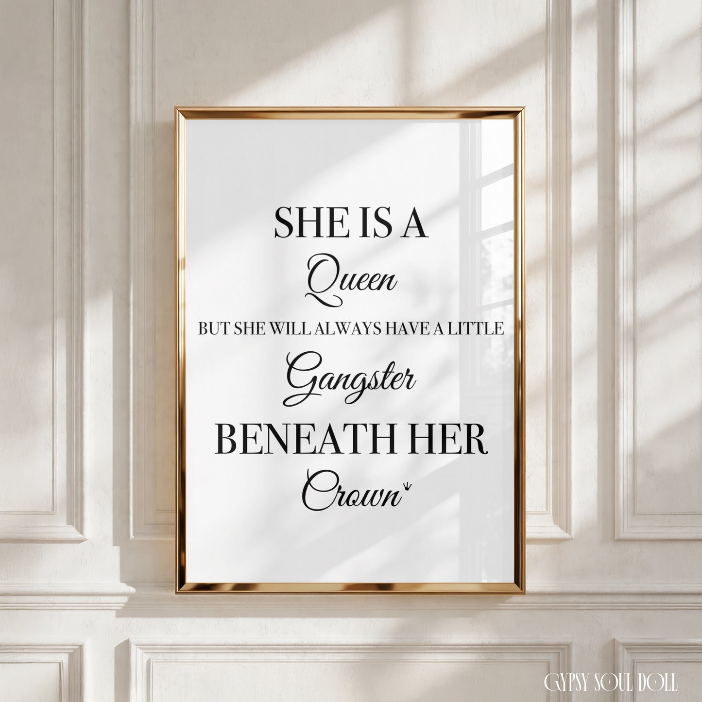 Empowering sassy print featuring a clean white backdrop and black typography reading
"She is a Queen, but she will always have a little Gangster beneath her Crown".