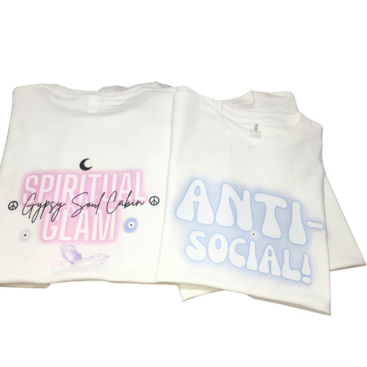 Two folded white graphic t-shirts side by side displaying the original script logo print on the back and the fuzzy Anti-Social airbrush design on the front.