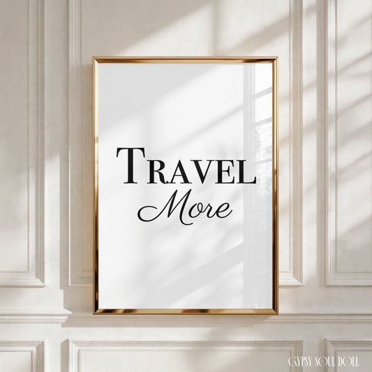 Minimalist A4 black and white typography poster print displaying the bold adventure motivation quote Travel More in elegant serif lettering.