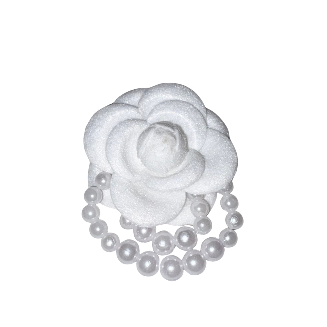 Close-up front view of the frosted white velvet camellia flower brooch pin decorated with elegant double-layered draped faux pearl bead loops.