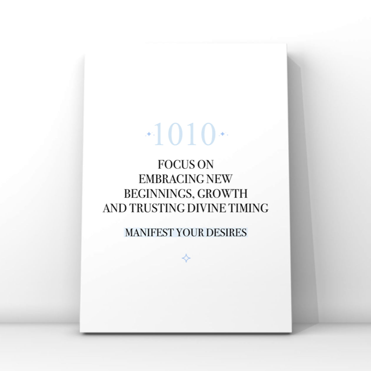 Minimalist typography print featuring a blue 1010 angel number and a pastel blue background highlight behind the words Manifest Your Desires.
