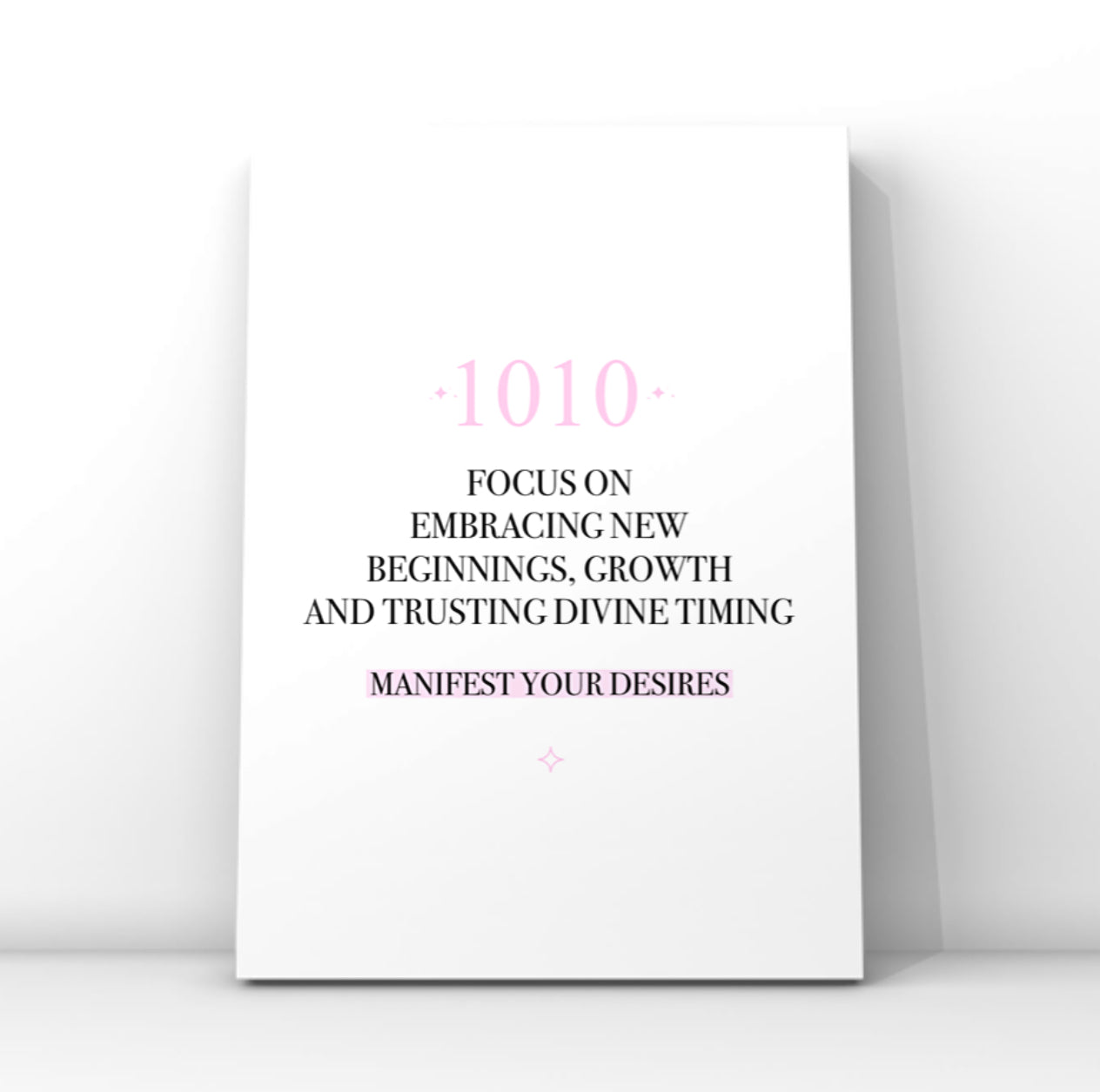 Minimalist typography print featuring a pink 1010 angel number and a pastel pink background highlight behind the words Manifest Your Desires.