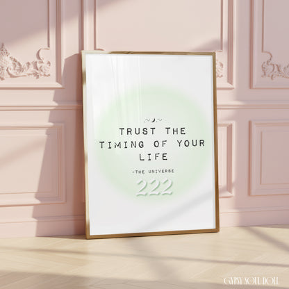 Soft girl aesthetic typography art print reading Trust The Timing Of Your Life with a white 222 angel number over a pastel green aura halo.