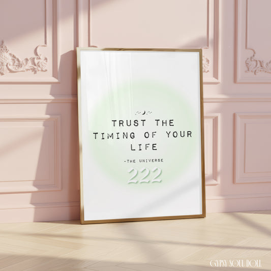 Soft girl aesthetic typography art print reading Trust The Timing Of Your Life with a white 222 angel number over a pastel green aura halo.