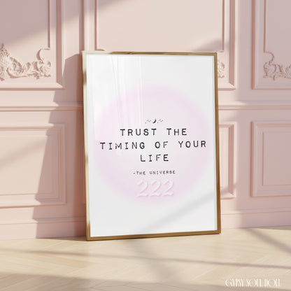 Soft girl aesthetic typography art print reading Trust The Timing Of Your Life with a pink 222 angel number over a pastel pink aura halo.