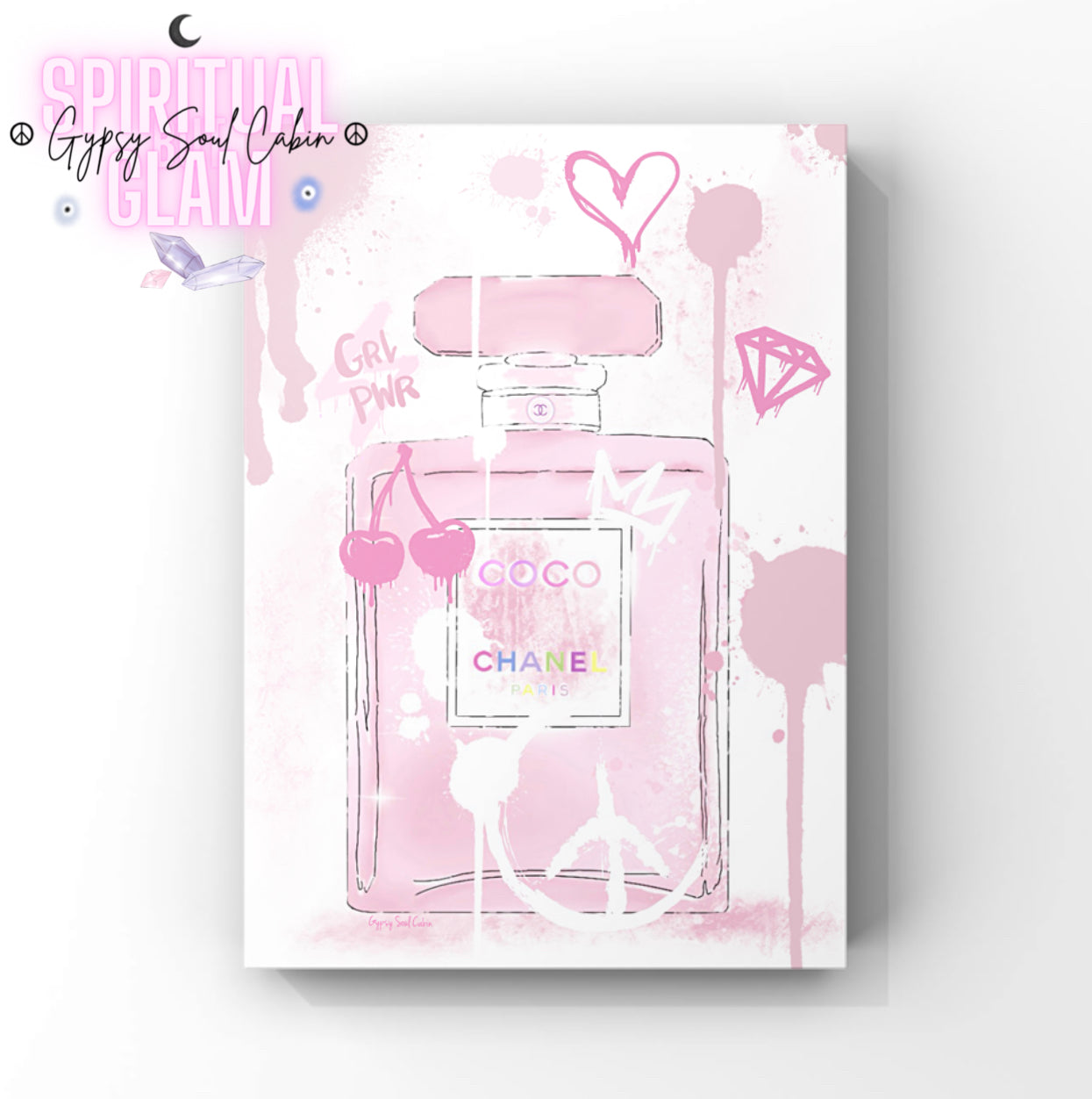 Pink Chanel perfume bottle with decorative elements on a white background.