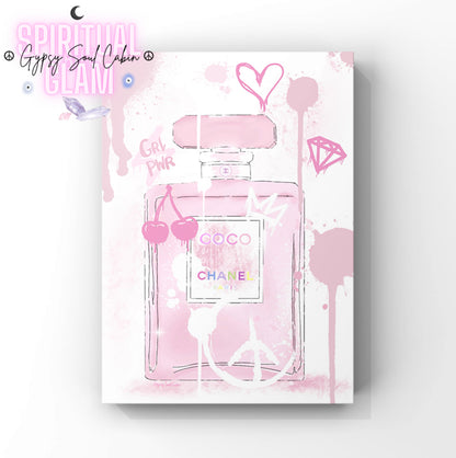 Pink Chanel perfume bottle with decorative elements on a white background.