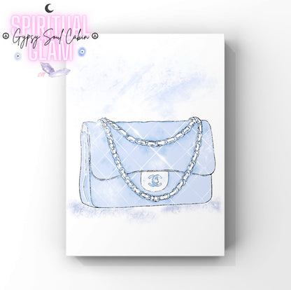 Light blue Chanel handbag with chain detail on a watercolour background.
