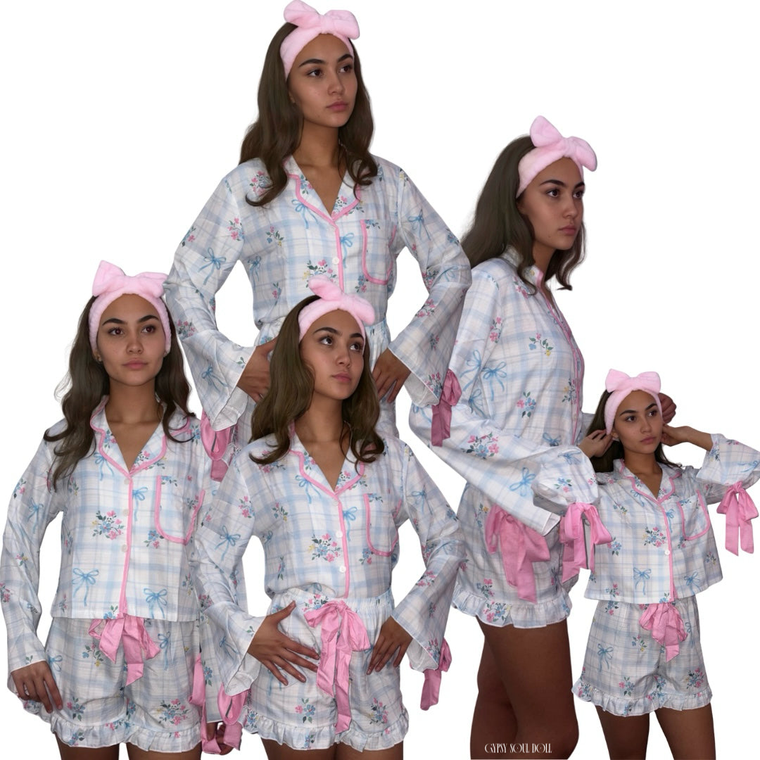 A studio collage display showing five unique angles of a model wearing a pastel blue and white plaid luxury sleepwear set decorated with pink ribbons, floral sprays, a frilled short hemline, and a plush pink spa headband against a plain white background by Gypsy Soul Doll.