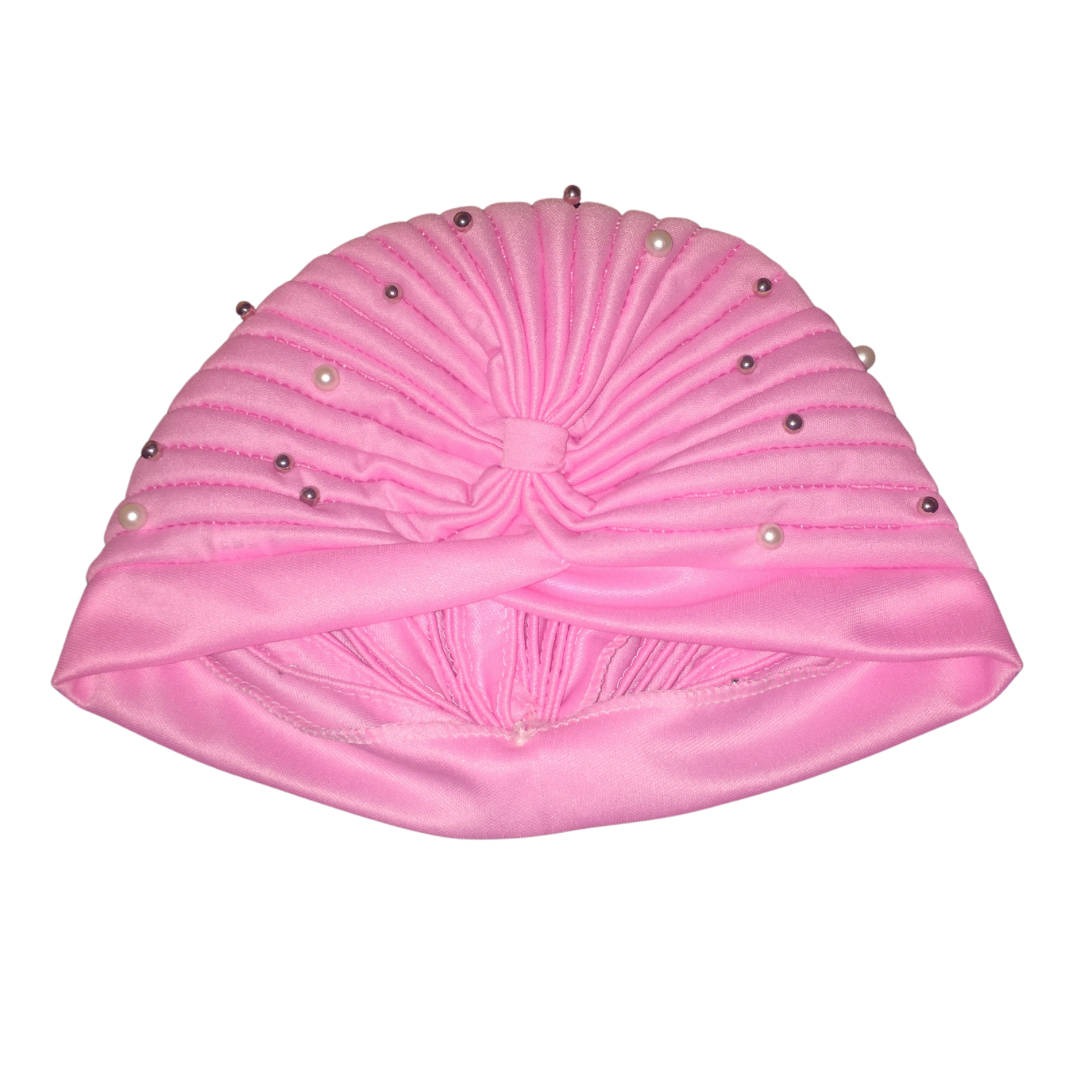 Close-up of a pink satin bohemian gypsy head wrap adorned with pearl beads, showcasing its gathered, ruched design and decorative details.