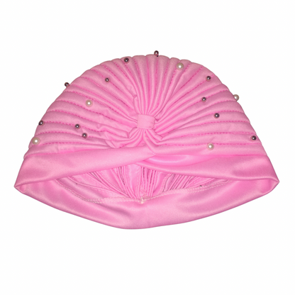 Close-up of a pink satin bohemian gypsy head wrap adorned with pearl beads, showcasing its gathered, ruched design and decorative details.