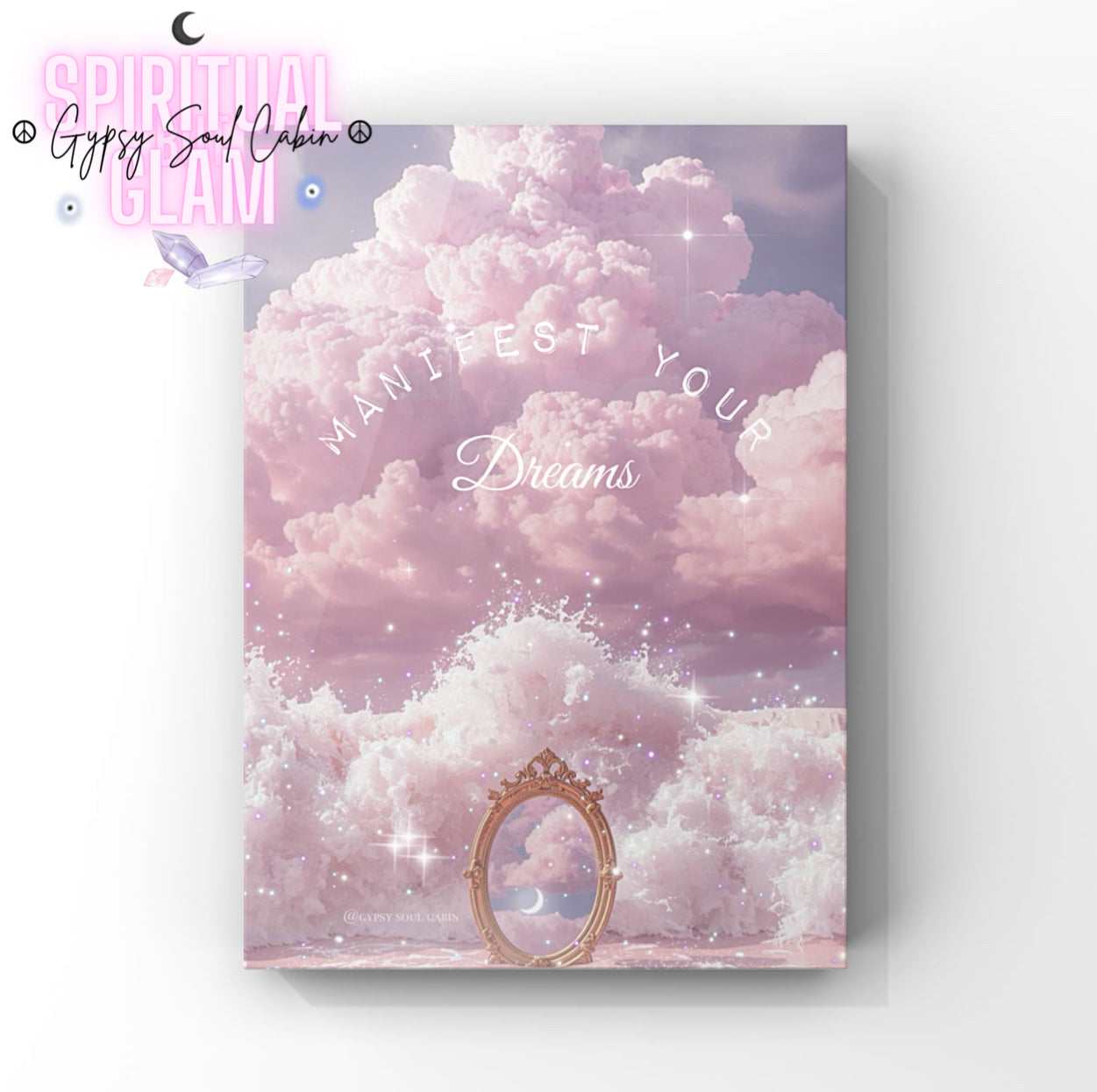Inspirational wall print with pink clouds, a mirror, the moon and the phrase 'Manifest Your Dreams' in white curved text, designed to motivate and inspire positive thinking.
