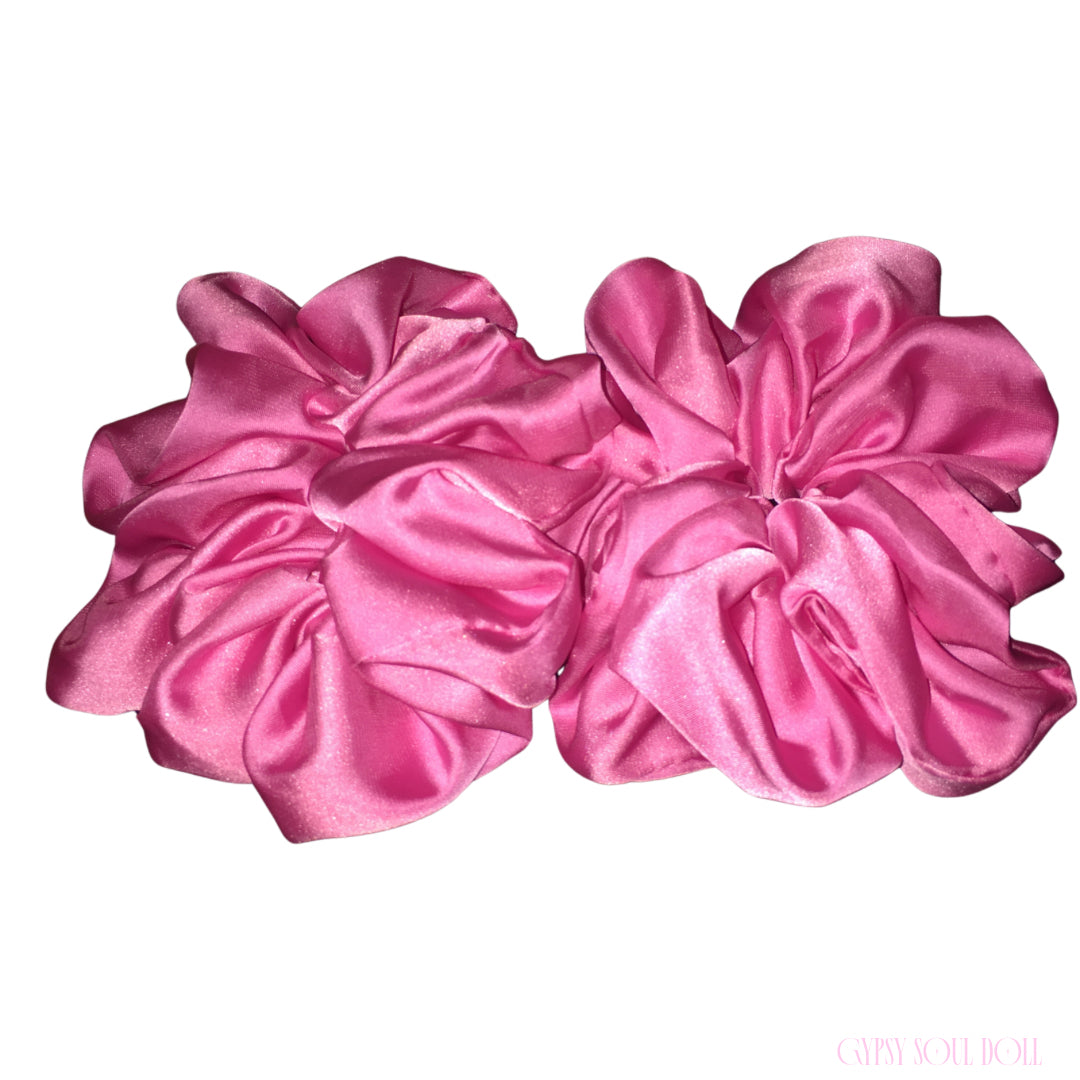 Two large pink satin hair scrunchies displayed side-by-side on a plain white background.