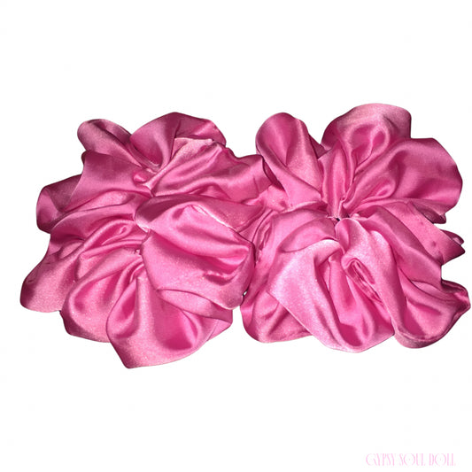 Two large pink satin hair scrunchies displayed side-by-side on a plain white background.