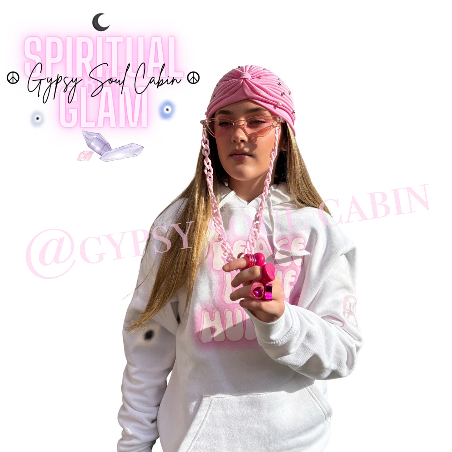 A pretty girl wearing a Gypsy Soul Cabin unique hoodie with pink accessories to match such as pink fashion glasses, pink fashion Y2T style rings and gypsy head wrap on a fresh white background.