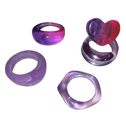 Flat lay view of the Gypsy Soul Doll Grape Soda candy acrylic ring collection highlighting the glossy violet and lavender tones.