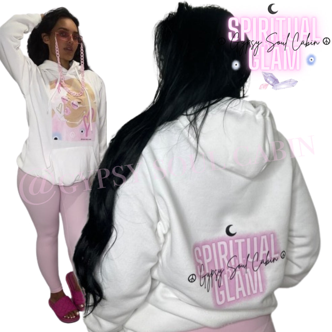 White oversized hoodie featuring a colourful graphic of a girl with sunglasses, surrounded by pink hearts and peace symbols, with "Spiritual Glam" text and the brand name "Gypsy Soul Cabin" on the back, with drawstrings and a front pocket.