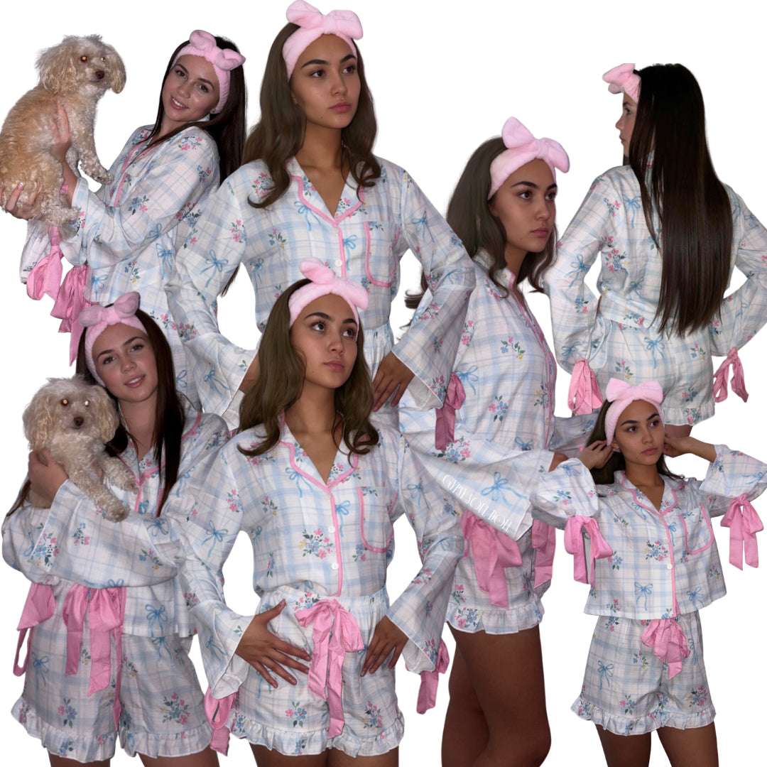 Multiple studio views of models showcasing a pastel blue and white plaid luxury short pyjama set featuring a vintage floral print, pink bow ties on the flared sleeves, pink ribbon drawstrings, and a matching plush pink bow headband by Gypsy Soul Doll.