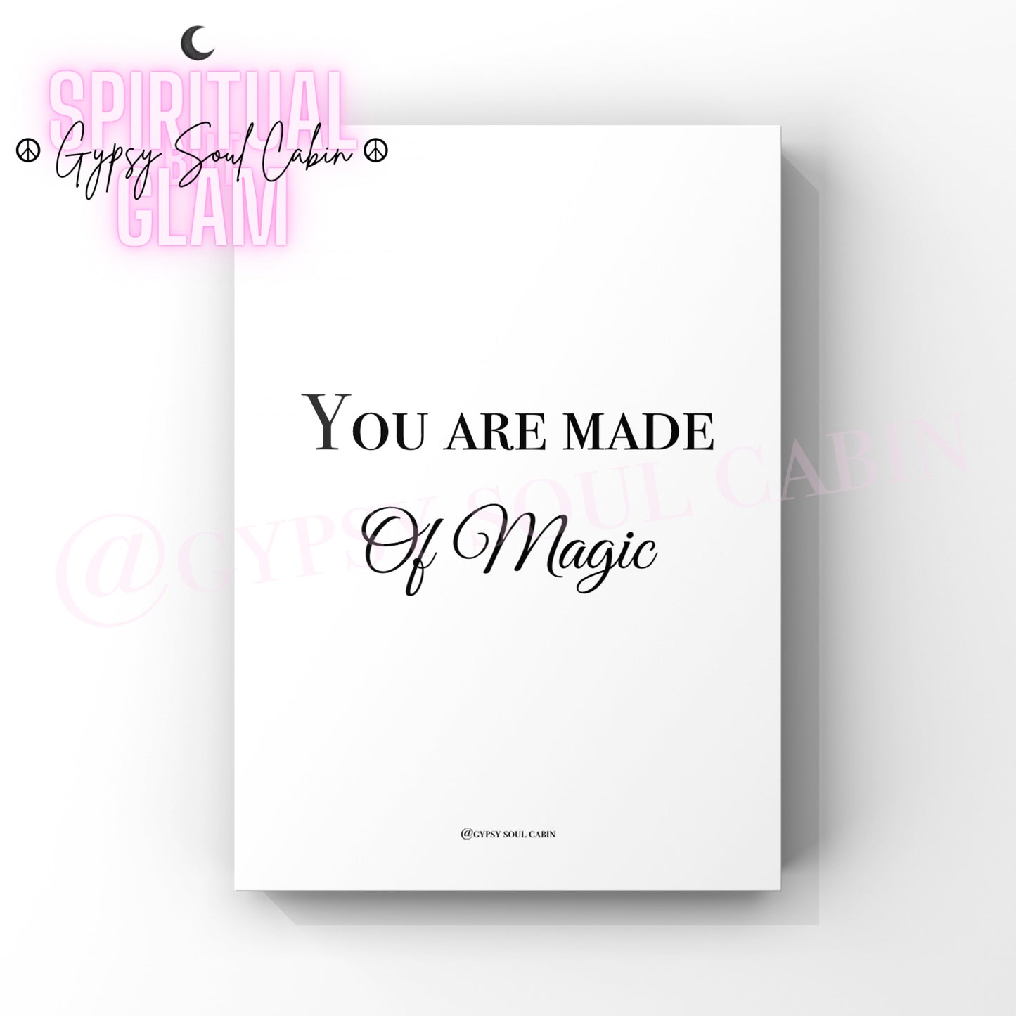 A black and white quote print with the text 'You are made of magic' and a moon symbol on the top right corner.