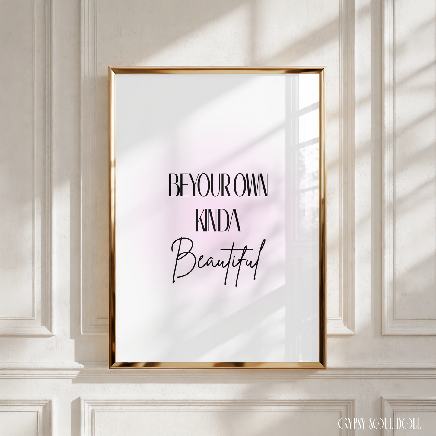 Sleek black typography motivational print displaying the text Be Your Own Kinda Beautiful centred over a soft blush pink aura gradient background.