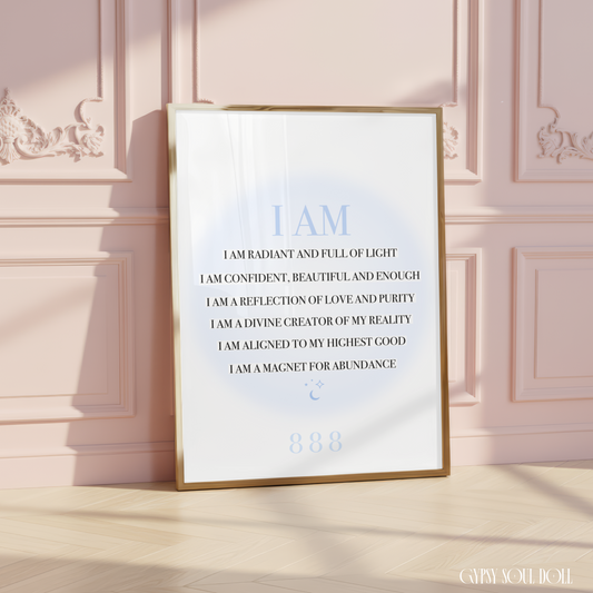 A4 spiritual typography print resting on a white surface, displaying a list of black I AM manifestation affirmations over a pastel blue aura gradient glow with an 888 angel number.
