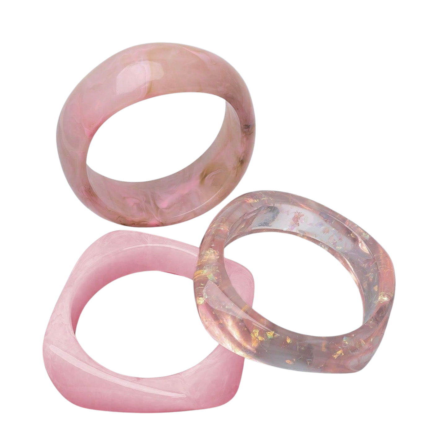 An isolated studio shot of three pink chunky resin wrist bangles including a marbled dome bracelet, a square band, and a translucent glitter-infused bracelet.