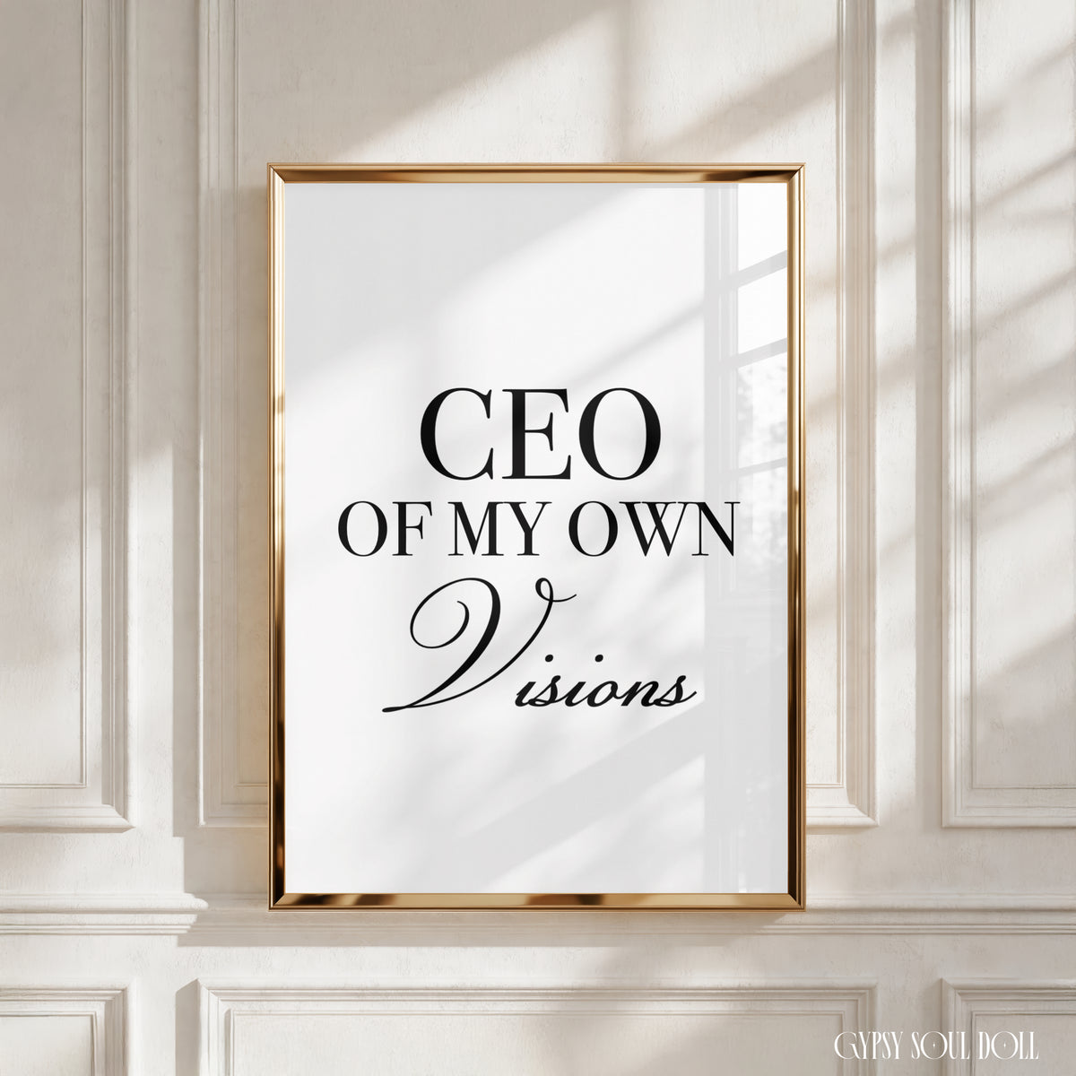 A framed typographic wall art print with the text 'CEO OF MY OWN Visions' in black lettering on a white background, mounted against a white panelled wall with soft window shadows by Gypsy Soul Doll.