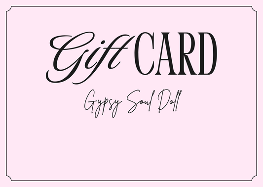 Soft pink digital gift card with a delicate dark border line, featuring the bold typography text Gift CARD and elegant handwriting script reading Gypsy Soul Doll.