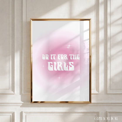 A framed art print with the text 'DO IT FOR THE GIRLS' in white against a pink and white gradient background, displayed on a white panelled wall with soft window shadows by Gypsy Soul Doll.