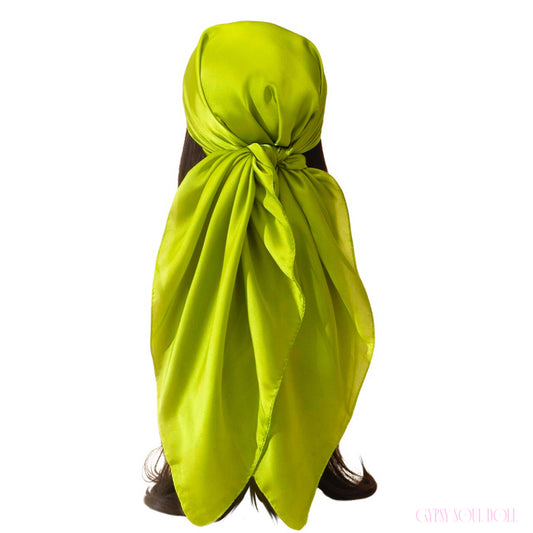 Vibrant lime green satin bohemian festival head wrap scarf tied in a gypsy bandana style on long dark hair.