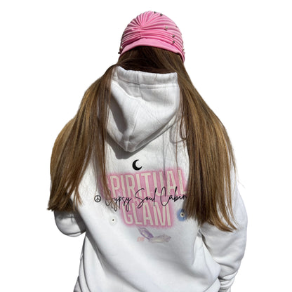 Back view of a model with long brown hair wearing a pink textured hat, showcasing the authentic large pink and black Gypsy Soul Cabin logo print with Spiritual But Glam text on the reverse of a white hoodie.