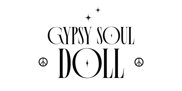 Black typographic graphic reading 'GYPSY SOUL DOLL' with decorative stars and peace-sign motifs on a plain white background.