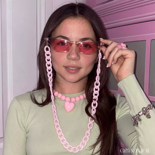 Front view of a model with long brown hair wearing a sage green top and the Gypsy Soul Doll Heart Breaker chunky pink ball-beaded necklace featuring a central puffy pink heart charm.