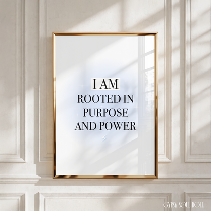 Powerful manifestation wall art print with a light blue aura glow reading I Am Rooted In Purpose And Power in bold black uppercase letters with a subtle lightning bolt detail.