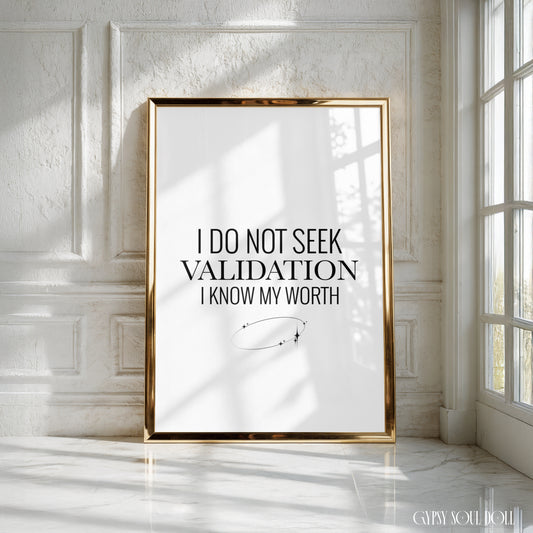 A framed motivational art print with the text 'I DO NOT SEEK VALIDATION I KNOW MY WORTH' in a black serif font on a white background, enclosed in a thin gold frame. The print is leaning against a white panelled wall in a bright room, with natural window light casting shadows, by Gypsy Soul Doll.