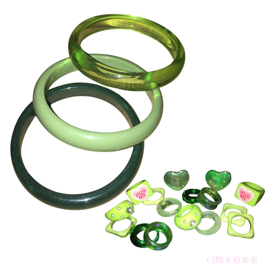 A stacked trio of Gypsy Soul Doll lime green acrylic bangle bracelets featuring a translucent neon lime band, a solid pastel sage ring, and a deep glossy forest green style with matching chunky retro rings against a plain white background.