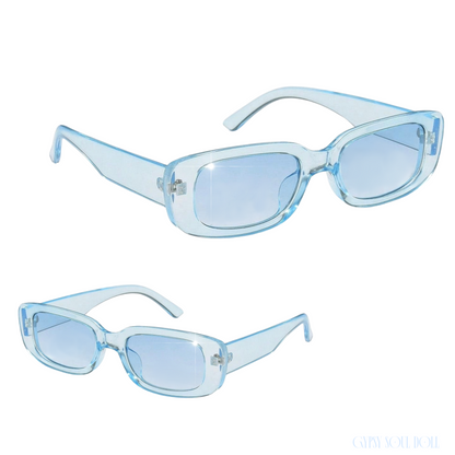 Studio product shot showcasing a pair of translucent ice blue rectangular fashion glasses from two different front and angled perspectives.