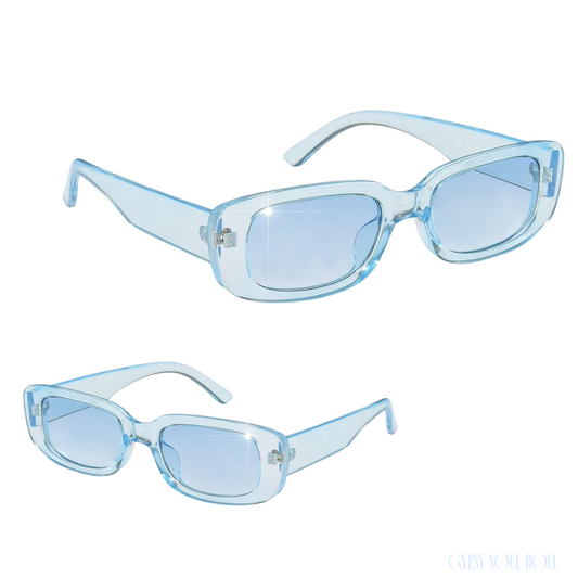 Studio product shot showcasing a pair of translucent ice blue rectangular fashion glasses from two different front and angled perspectives.