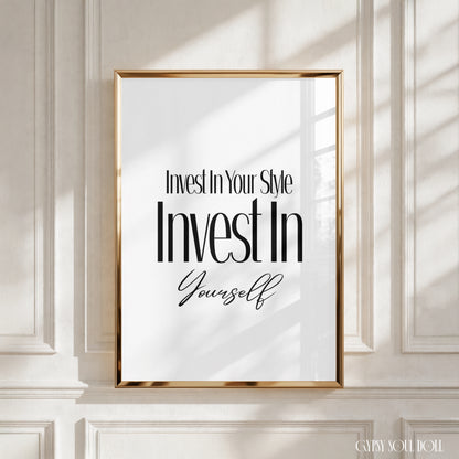 A framed motivational wall art print with the text 'Invest In Your Style Invest In Yourself' in black typography on a white background, enclosed in a thin gold frame and displayed against a white panelled wall with soft window shadows by Gypsy Soul Doll.