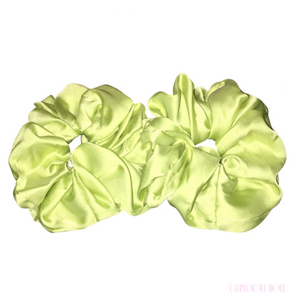 Two lime green satin hair scrunchies displayed side-by-side on a plain white background.