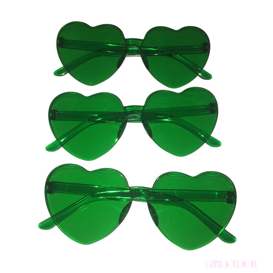 A vertical stack of three pairs of Gypsy Soul Doll Lovers Lane translucent green heart-shaped sunglasses displaying a frameless Y2K design against a plain white background.