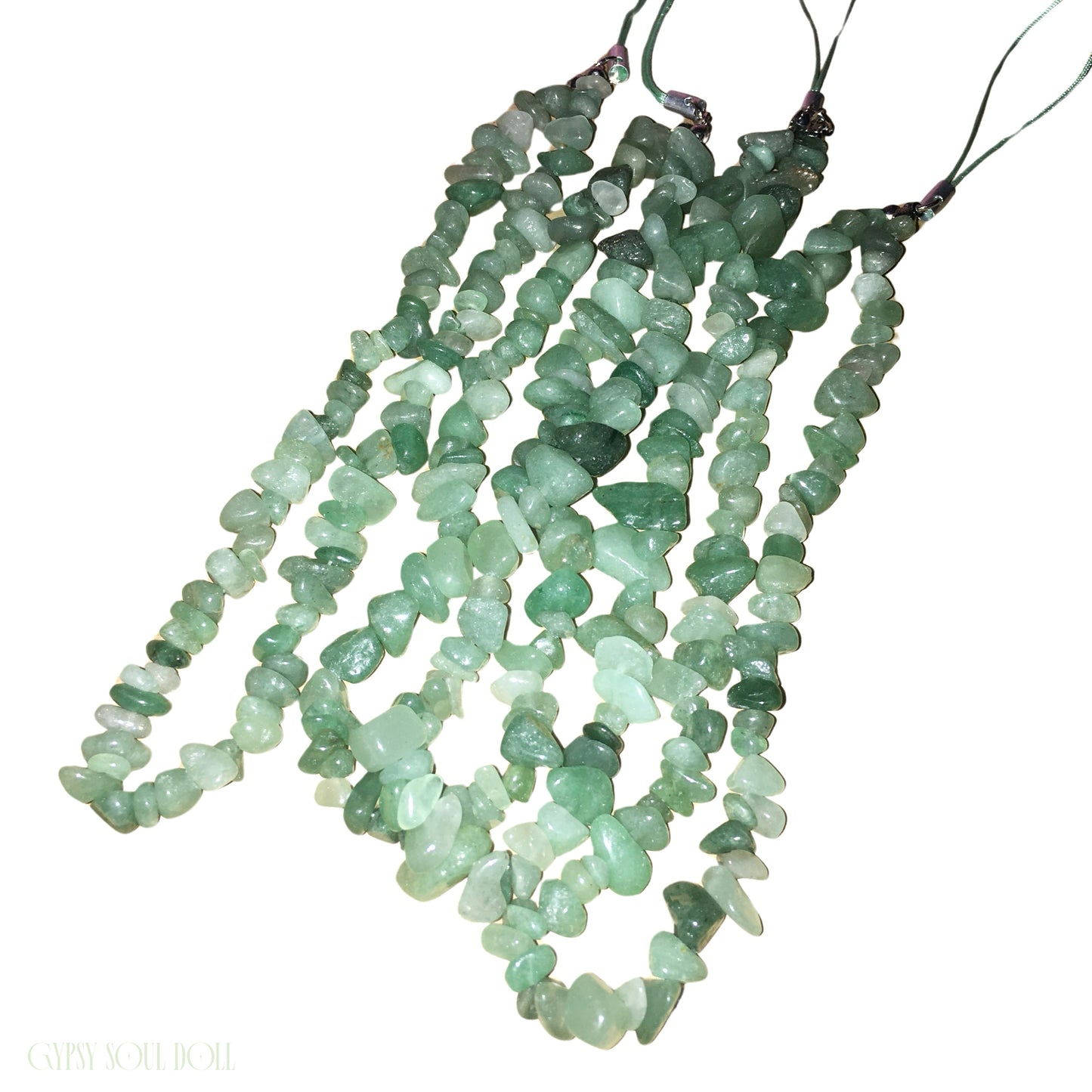 A collection of several Gypsy Soul Doll Mint Magic phone wrist straps featuring raw, polished irregular green aventurine crystal stone chips strung together on green cords against a clean white backdrop.