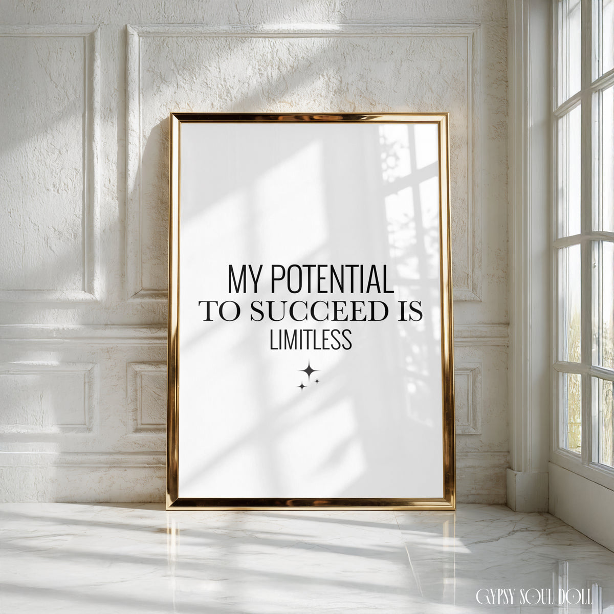 A framed motivational poster with the text 'MY POTENTIAL TO SUCCEED IS LIMITLESS' in black serif font on a white background, leaning against a white panelled wall in a sunlit room with a gold frame by Gypsy Soul Doll.
