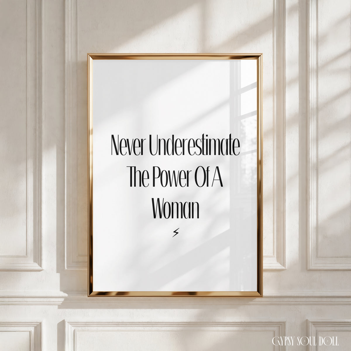 Minimalist A4 typography wall art print reading Never Underestimate The Power Of A Woman in a tall black font with a sharp black lightning bolt symbol at the bottom.