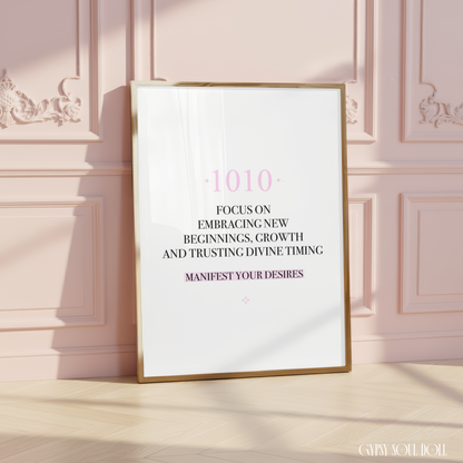 Minimalist A4 manifestation wall art print featuring the 1010 angel number in soft pink typography above a black text quote about embracing new beginnings, growth, and trusting divine timing, framed on a wooden floor against a pink panelled wall.