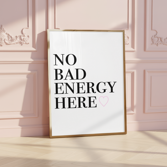 Minimalist A4 typographic wall art print featuring bold black stacked serif text reading NO BAD ENERGY HERE, paired with a small centred soft pink outline heart graphic.