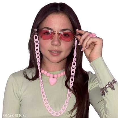 Front view of a model with long brown hair wearing a sage green top and the Gypsy Soul Doll Heart Breaker chunky pink ball-beaded necklace featuring a central puffy pink heart charm.